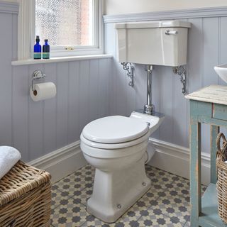 wash room with grey wall and commode