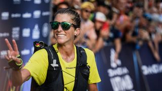 US trailer Courtney Dauwalter celebrates as she crosses the finish line to win the 20th edition of The Ultra Trail du Mont Blanc