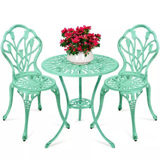 Mint green metal patio bistro set with small round table and two chairs with tulip motif on backs
