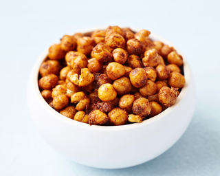 Crispy chickpeas coated in spice mix in a white ceramic bowl