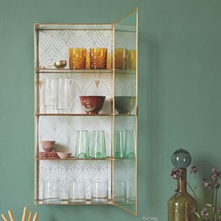 small glass wall cabinet with wallpaper background