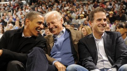 Barack Obama, Joe Biden and Hunter Biden talk during a college basketball game in 2010.