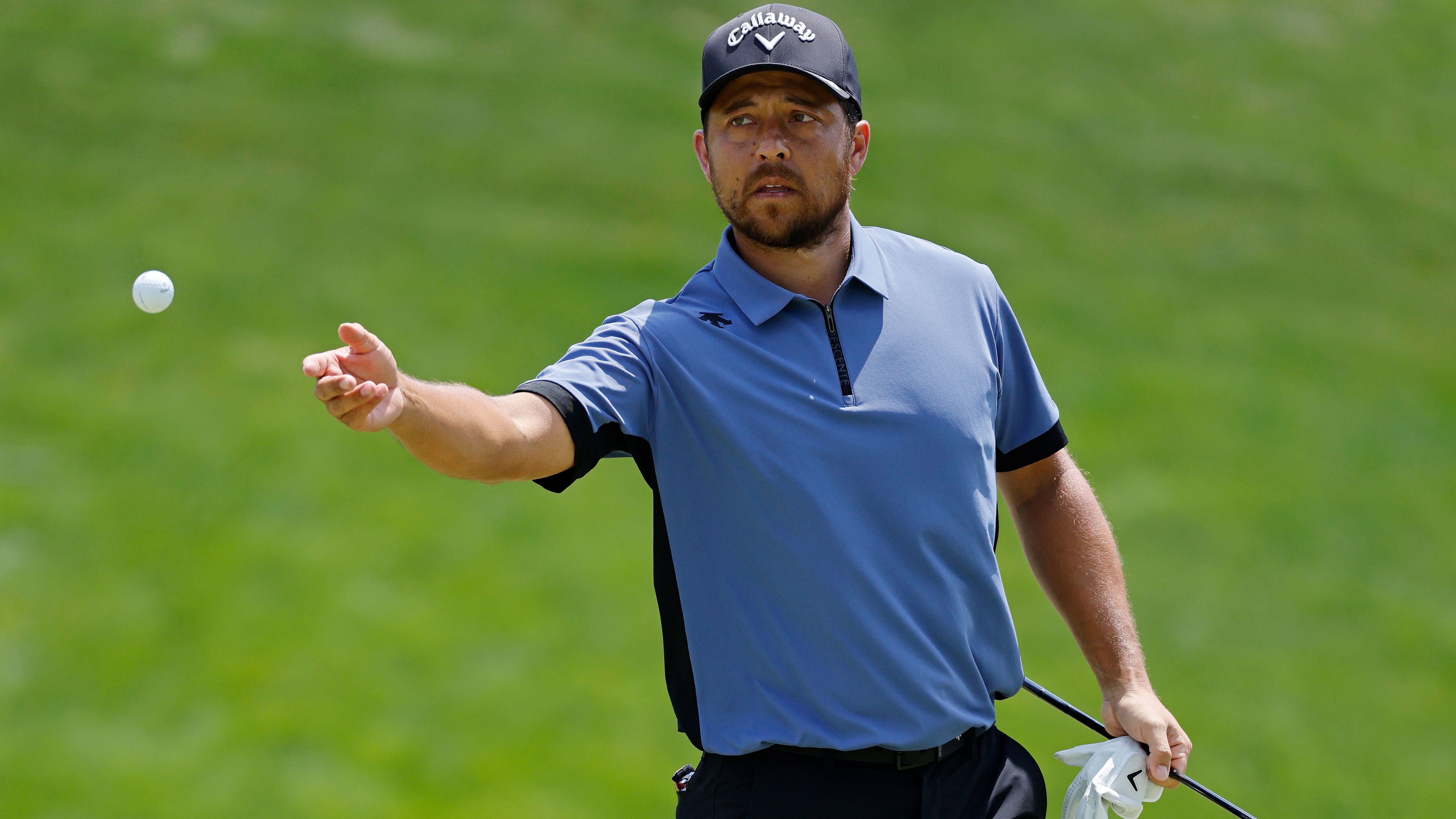 Xander Schauffele throws his Callaway golf ball 