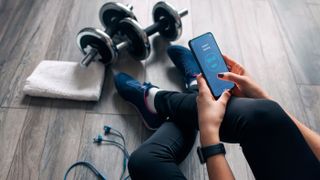 A photo of a woman using a workout app 