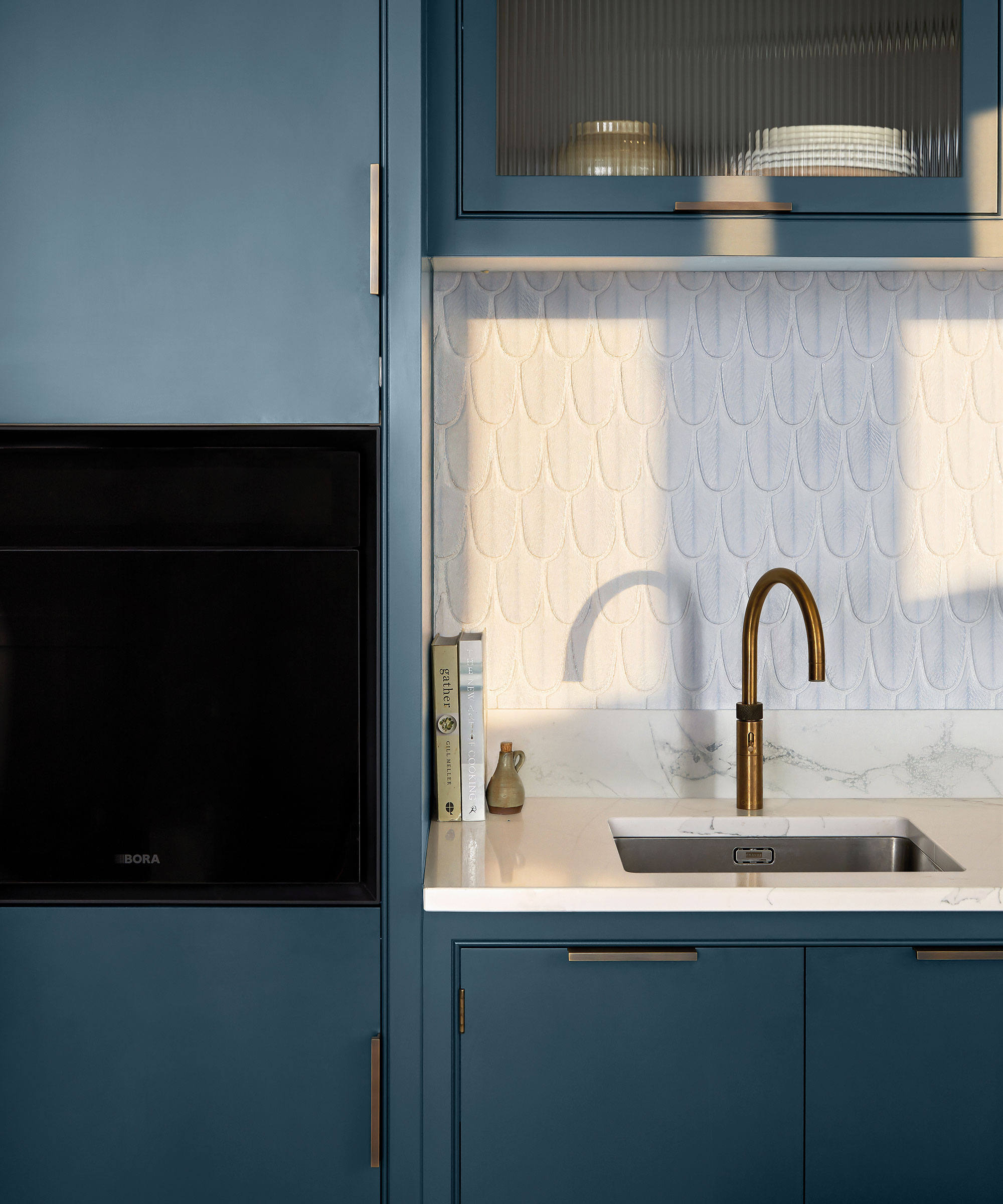 blue slim Shaker kitchen with inset sink and brass tap with built-in eye-level oven
