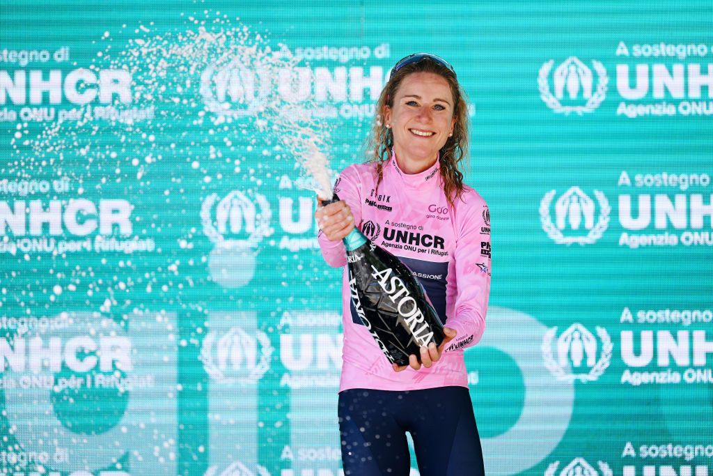 REGGIO EMILIA ITALY JULY 05 Annemiek Van Vleuten of Netherlands and Movistar Team celebrates winning the pink leader jersey on the podium ceremony after the 33rd Giro dItalia Donne 2022 Stage 5 a 1261km stage from Carpi to Reggio Emilia GiroDonne UCIWWT on July 05 2022 in Reggio Emilia Italy Photo by Dario BelingheriGetty Images