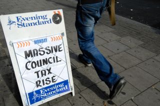 Headline on Evening Standard newspaper hoarding Massive Council Tax Rise London England UK