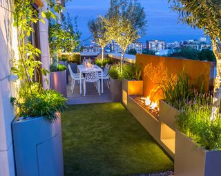 modern roof terrace with composite decking at night