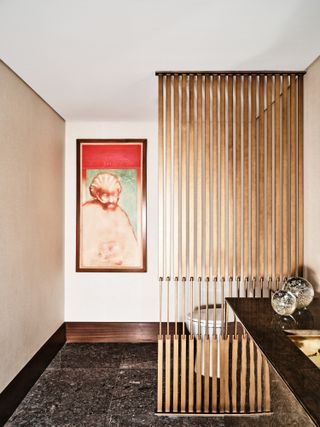 Bathroom with beige walls and red artwork