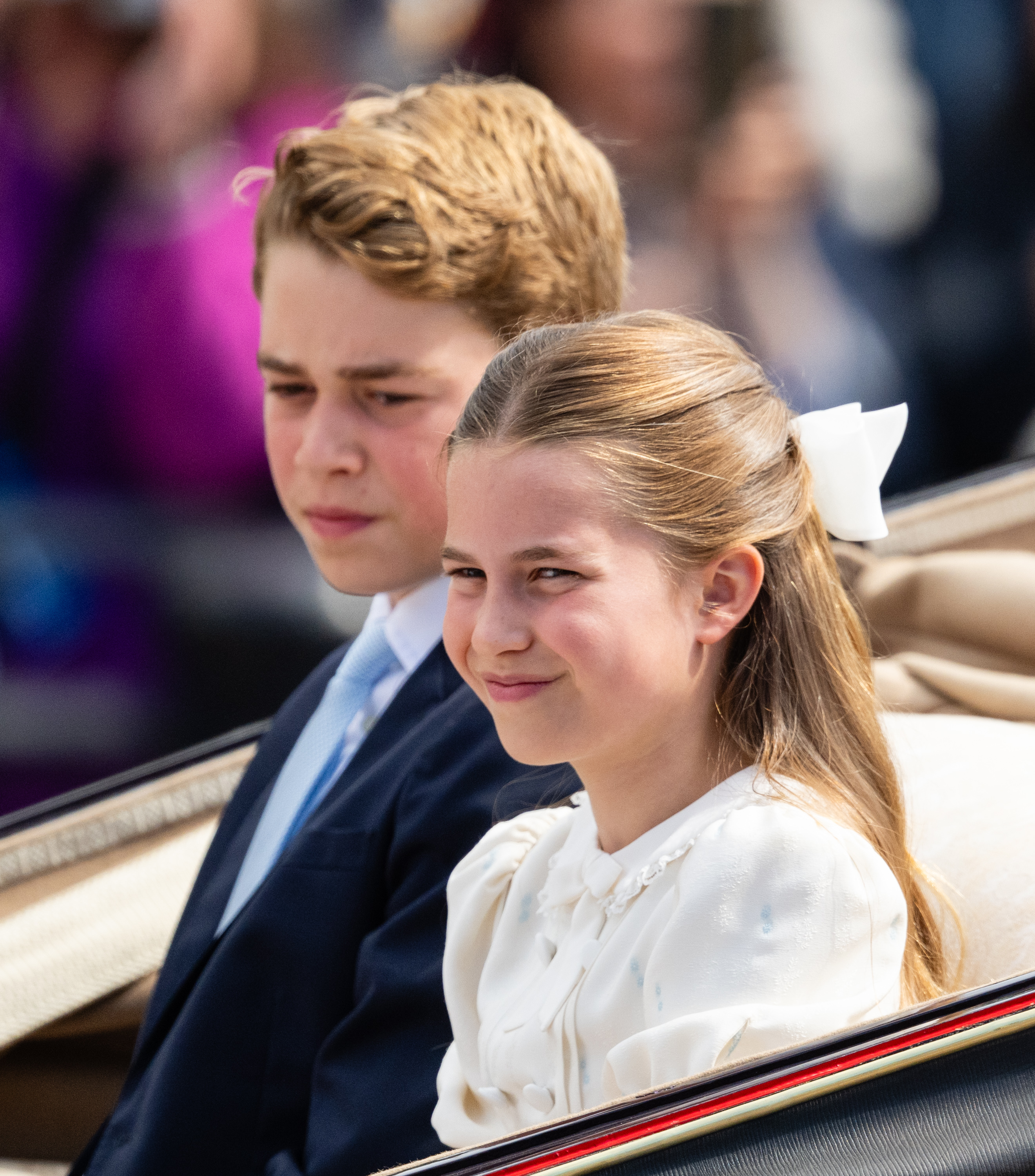 Princess Charlotte wears a white bow in her hair for Trooping the Colour 2026 and sits next to brother Prince George, who wears a suit