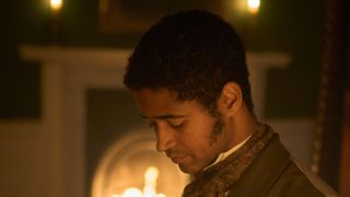 Alfred Enoch in a dark coat as Mr Lidderdale looks down in Miss Austen.