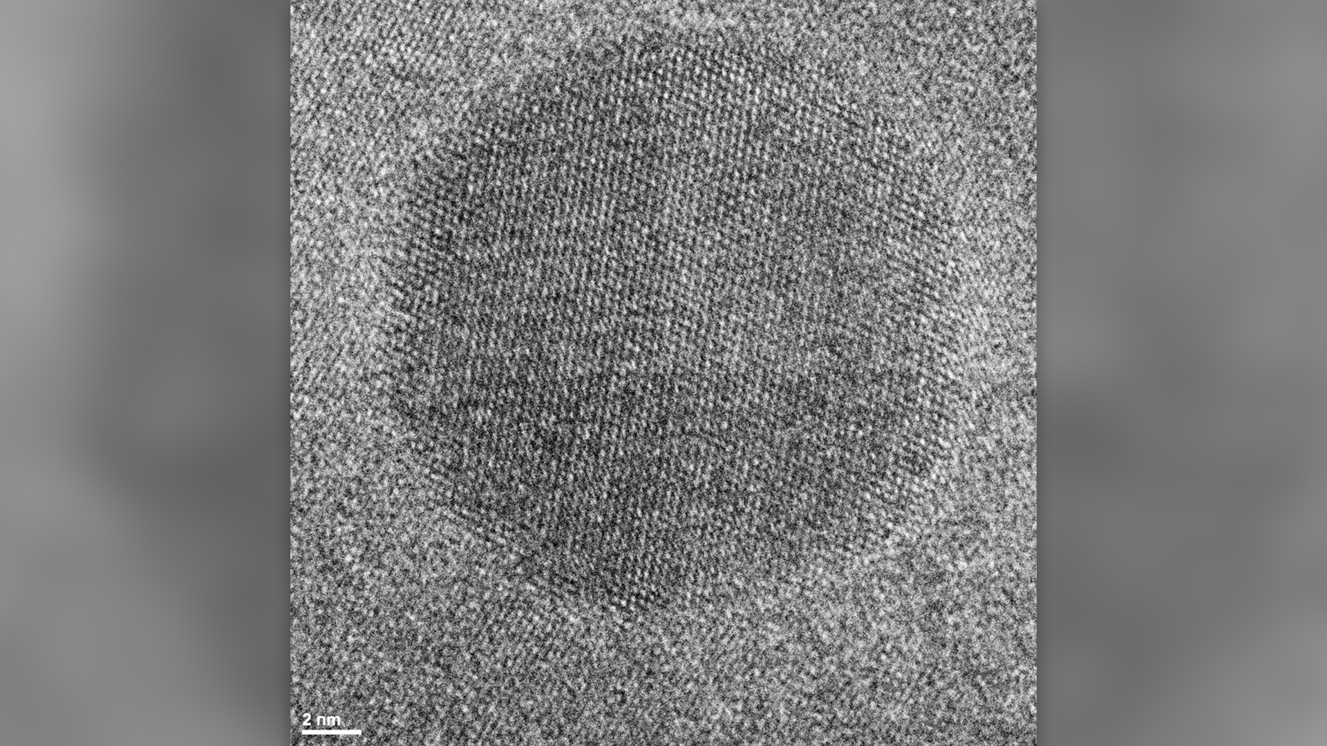 High-resolution TEM image showing tiny inclusion of cubic zirconia inside newly formed zircon. The crystal lattices of two minerals are visible, looking like a fabric texture.