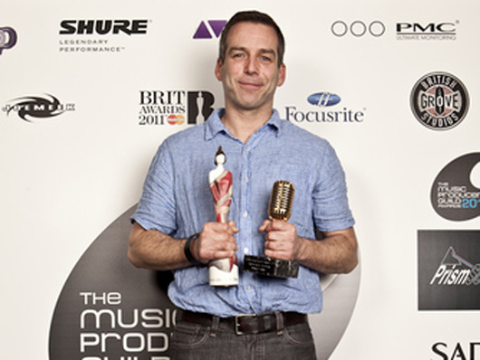 Markus Dravs clutches his MPG and Brit Awards.