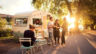 Best POS systems for food trucks: Customers outside a food truck on a sunny day