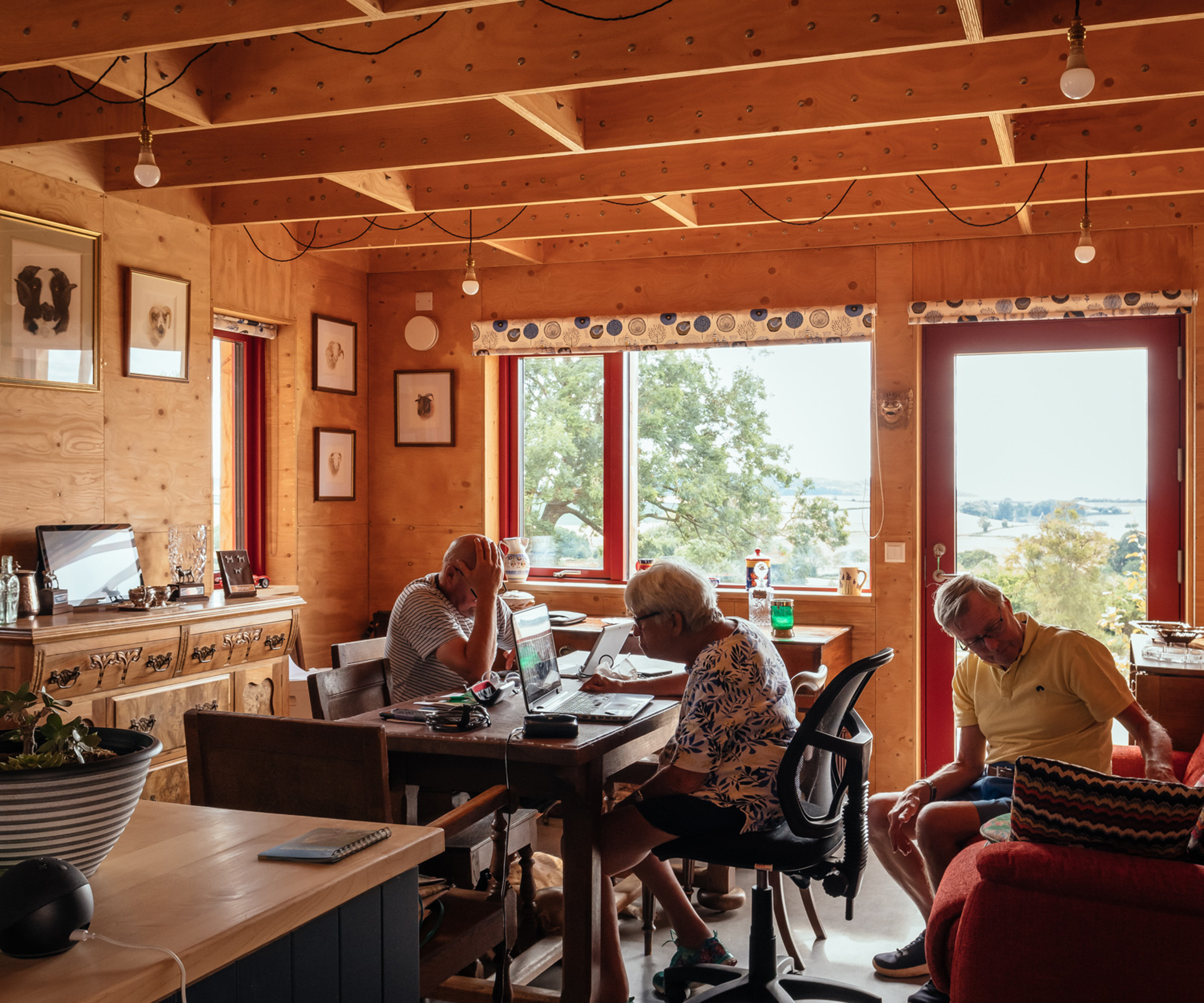 Elderly couple sitting at the dining table in their newly built timber modular home