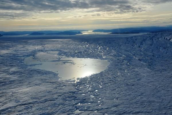 A shiny lake on top of Greenland ice. 