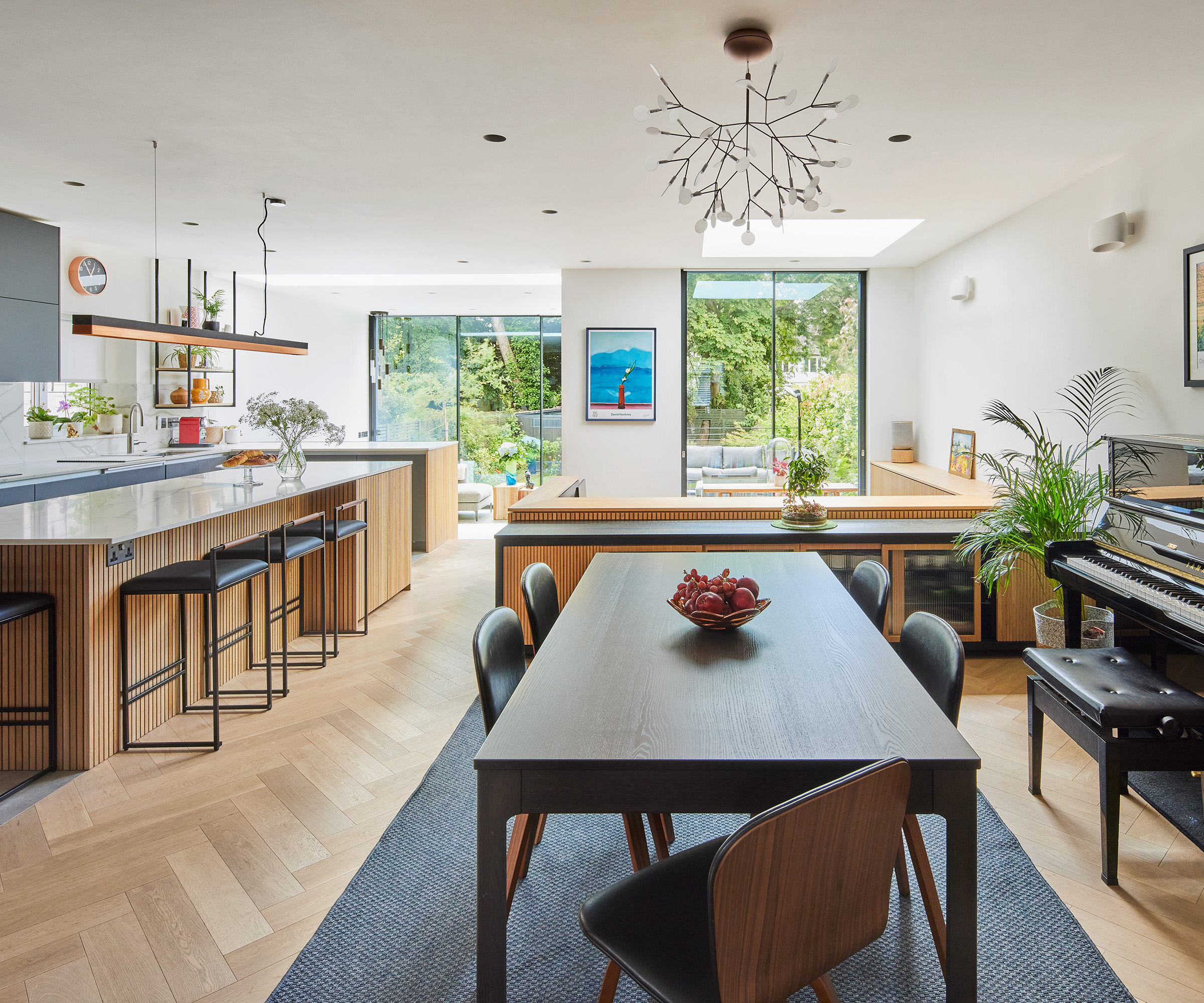 a bright open-plan kitchen and dining room with wooden flooring