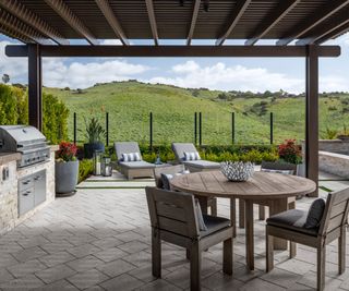 pergola covered patio with outdoor kitchen and dining area