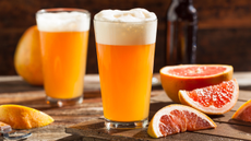 Fruit beer in a glass with slices of grapefruit