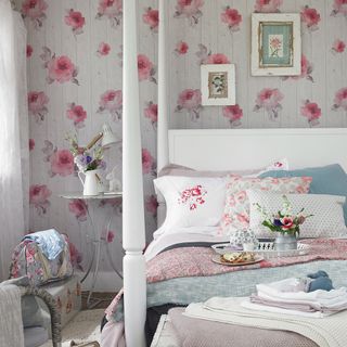 bedroom with floral designed wall white bed with designed cushions