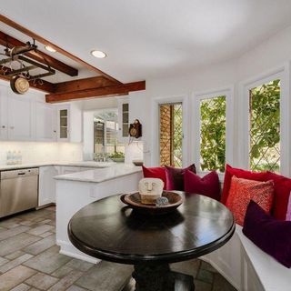kitchen area with white wall and round table
