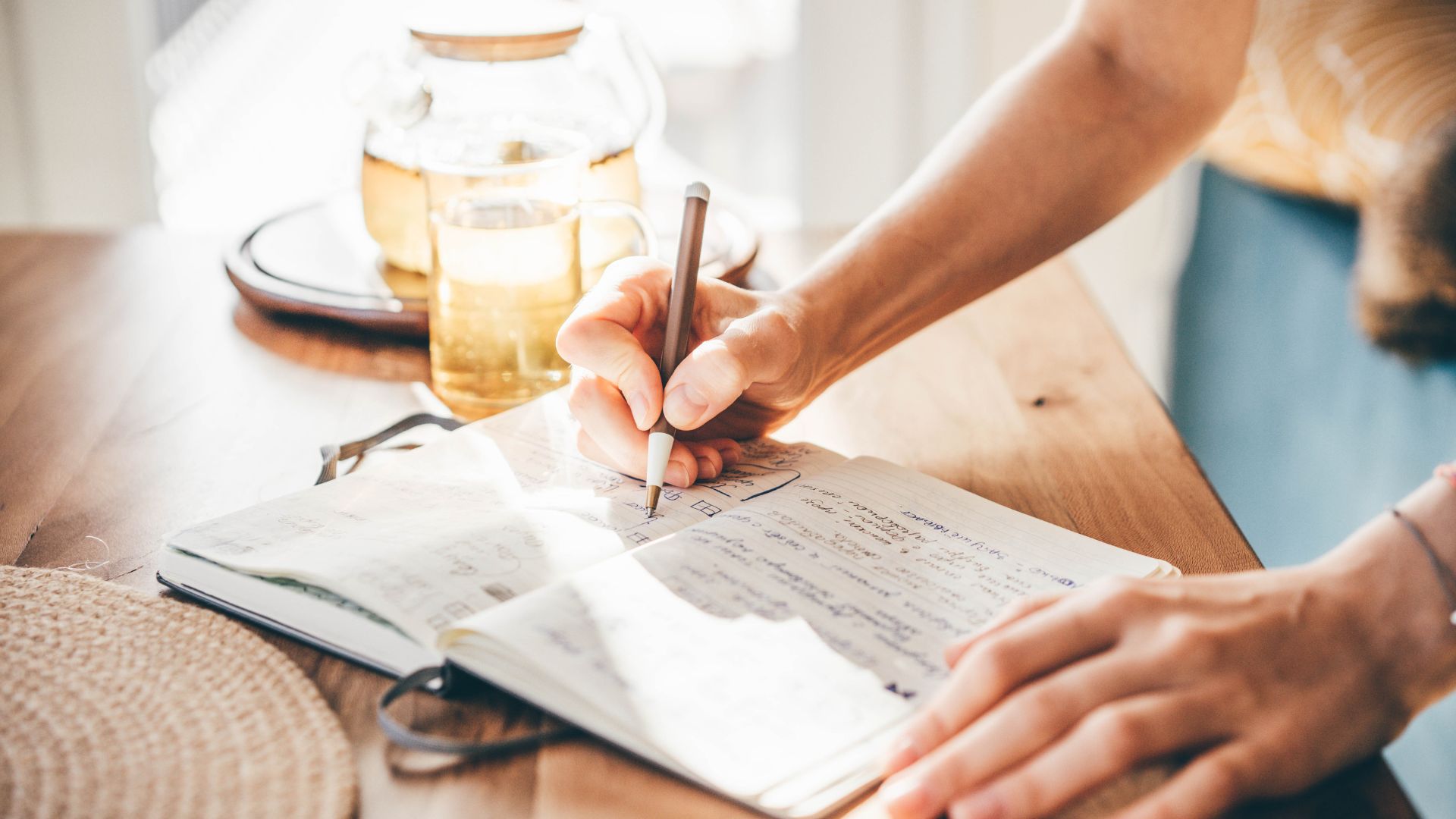 Woman writing in a new journal