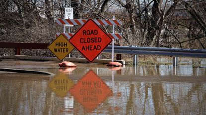 picture of road signs warning about high water and closed roads