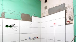 Bathroom with tiles applied to green plasterboard