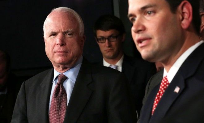 Sen. Marco Rubio speak as Sen. John McCain looks on during a news conference on a comprehensive immigration reform framework January 28, 2013 on Capitol Hill in Washington, DC.