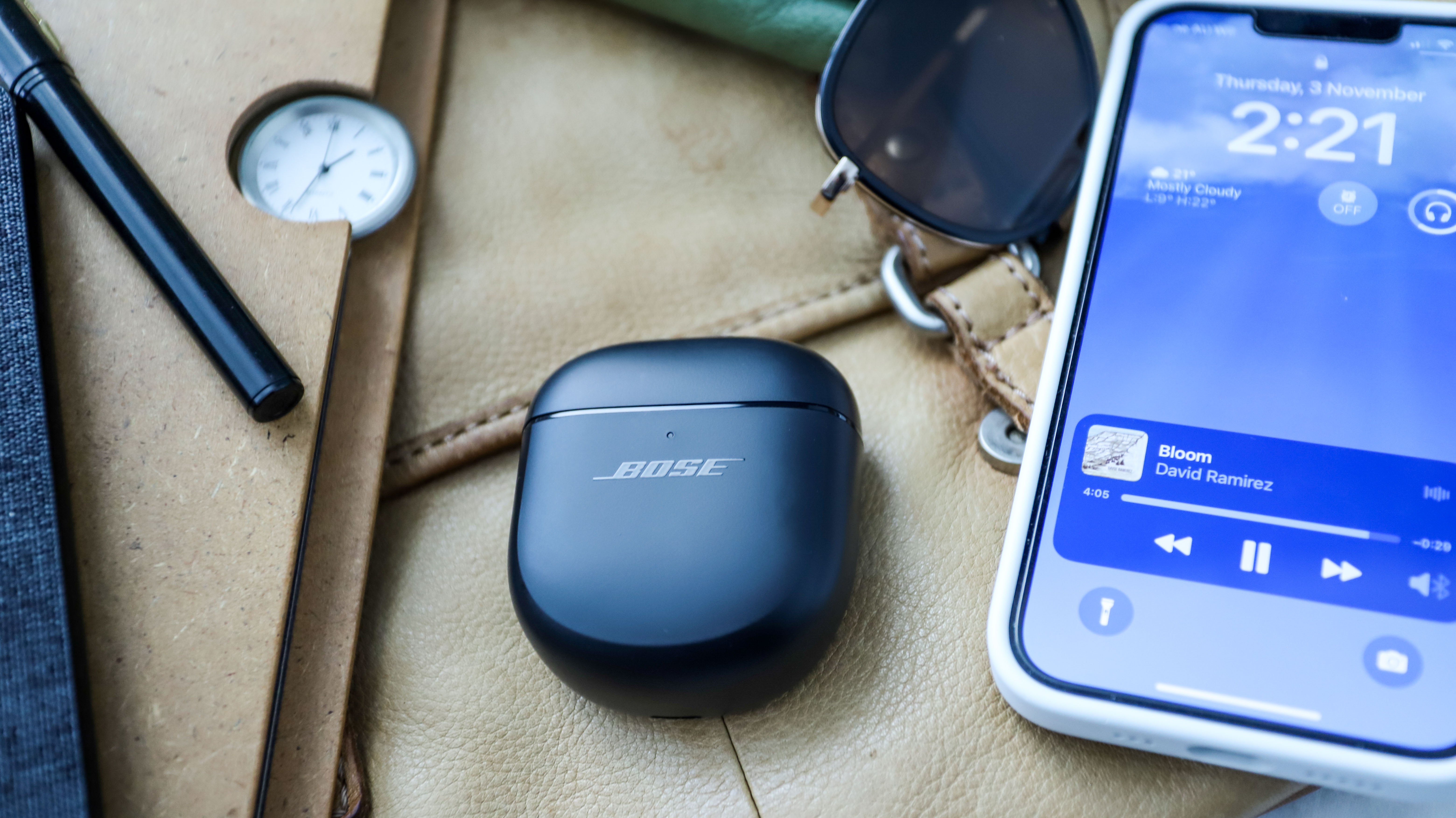 Bose QuietComfort Earbuds 2 case beside a phone