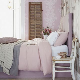 bedroom with pink wallpaper and bed