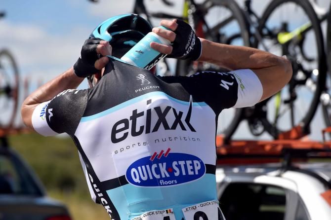 An Etixx-Quickstep rider fills up for the trip back into the peloton.