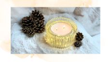 picture of light up candle surrounded by pinecones