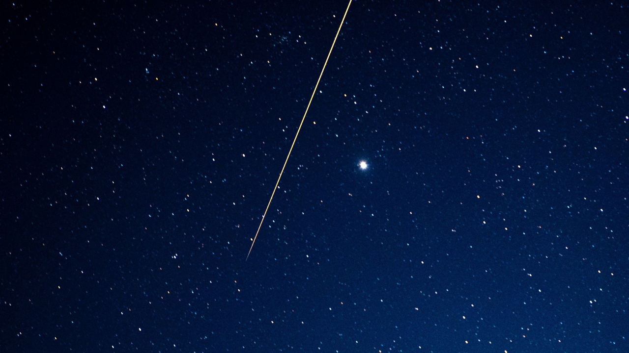 Asteroid flies through night sky