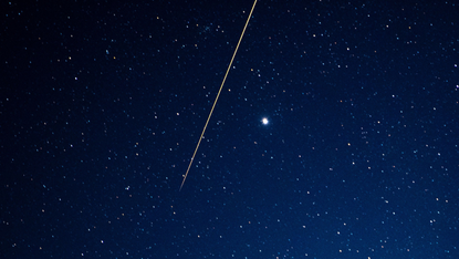 Asteroid flies through night sky