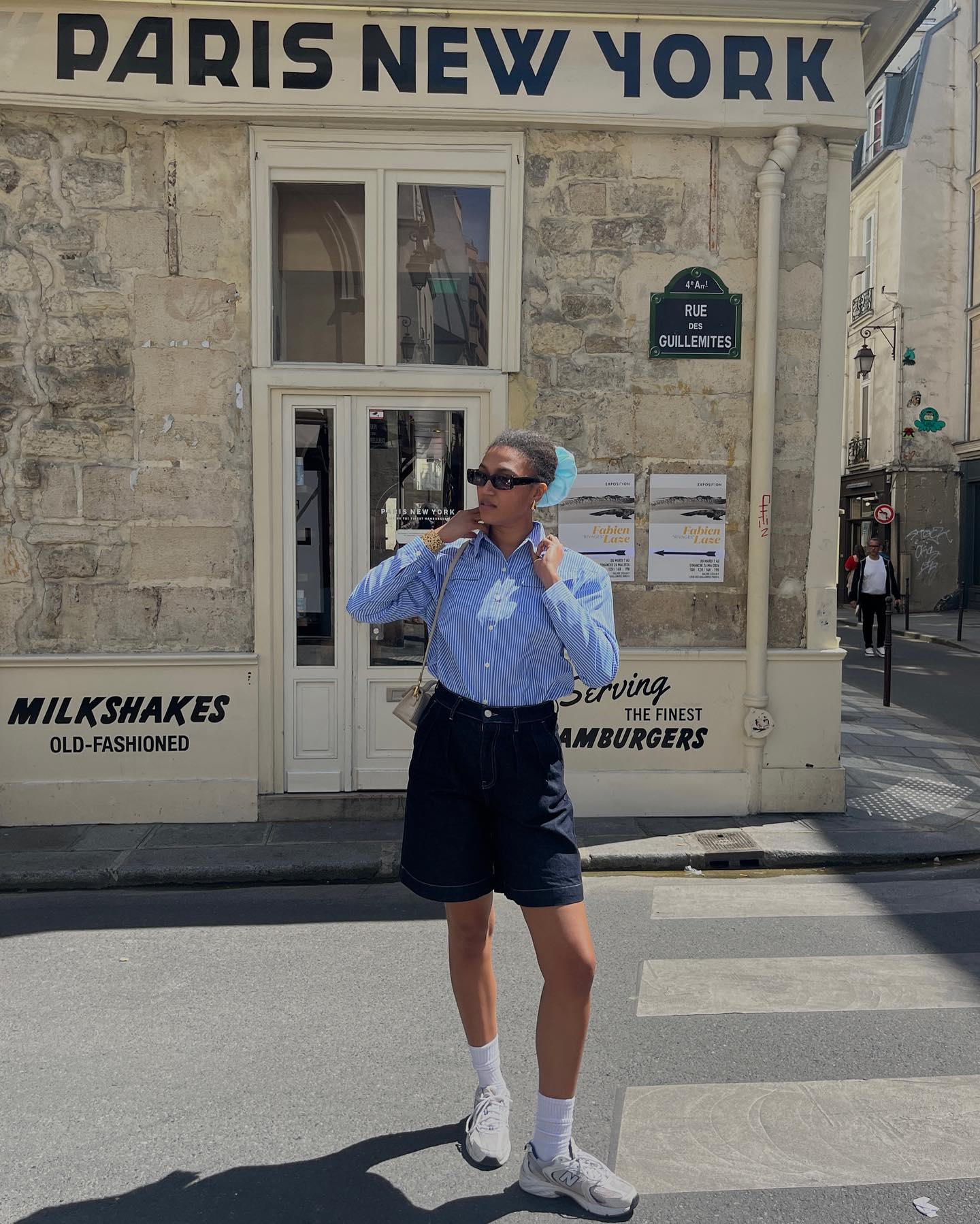 How a French girl wears baggy shorts and a button-up shirt