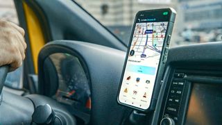 Waze conversational reporting on a phone attached to a taxi dashboard