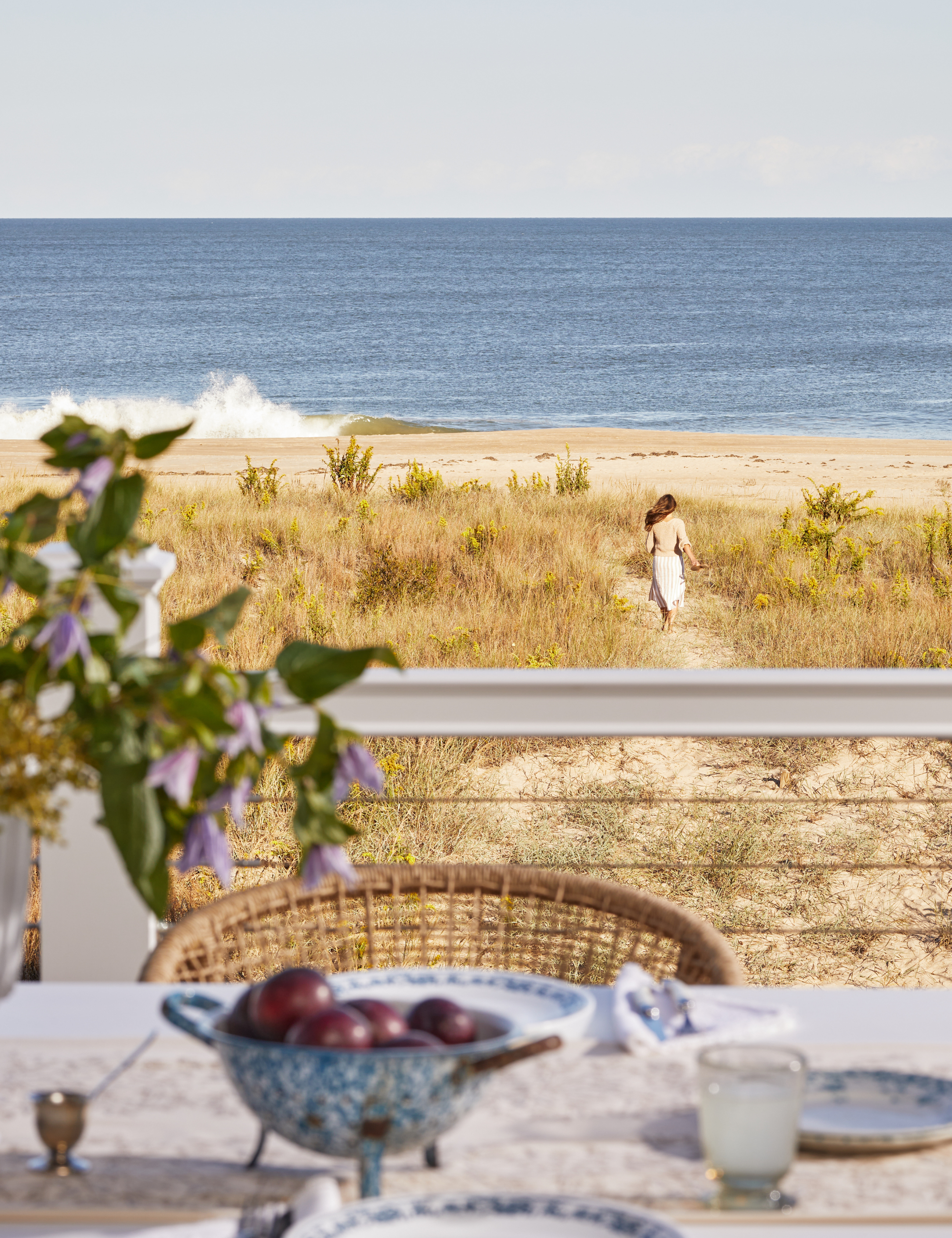 Outdoor tablescape looking out onto a sandy beach