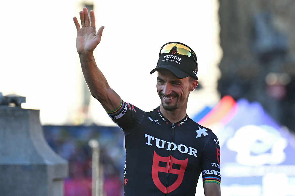 Tudor Pro Cycling Team&#039;s French rider Julian Alaphilippe waves to spectators on Lille&#039;s Grand&#039; Place during the official teams presentation days prior to the start of the 112th edition of the Tour de France cycling race, in Lille, northern France, on July 3, 2025. (Photo by Loic VENANCE / AFP)