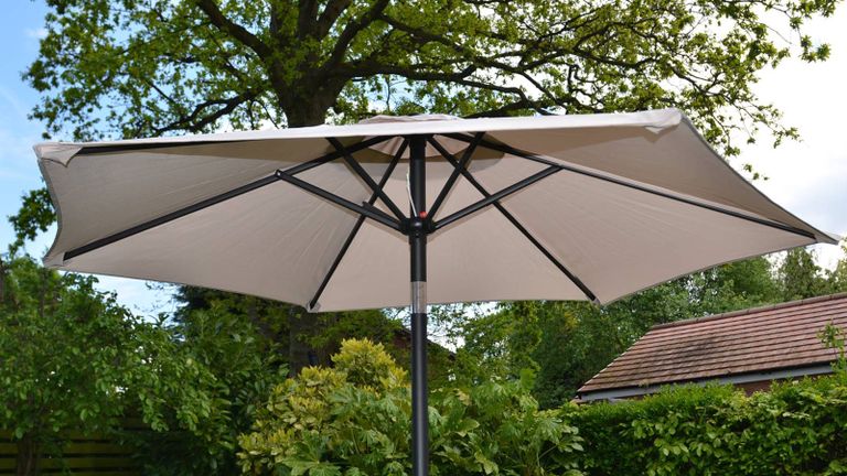 white patio umbrella in a garden