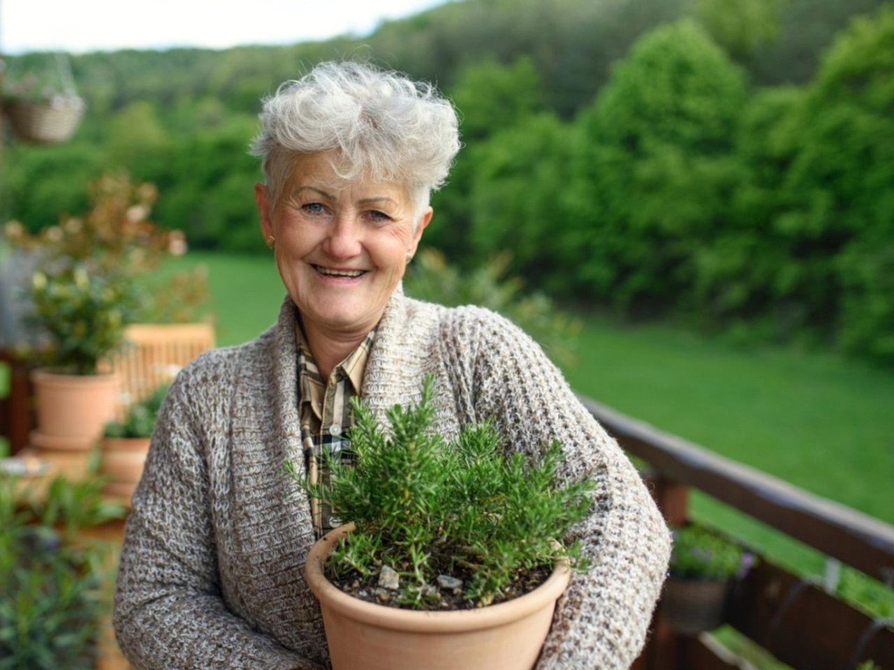 Elder Holding Potted Herbs