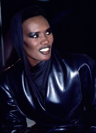 Grace Jones sporting a metallic purple suit