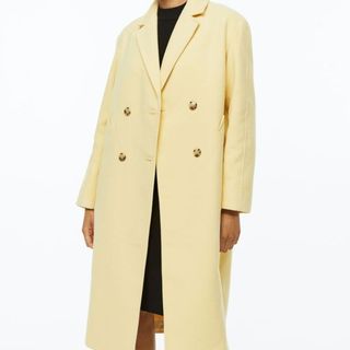 model wearing h&m mid length double breasted yellow coat