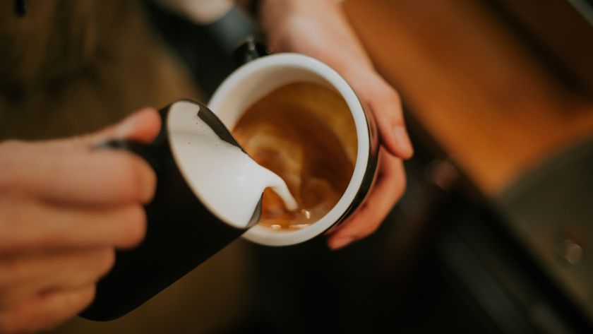 Barista hand while making latte ate with cappuccino menu at the cafe, routine, part-time job, small business