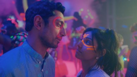 L-R: Riz Ahmed and Ritu Arya in a nightclub in a scene from Prime Video's "Bait"