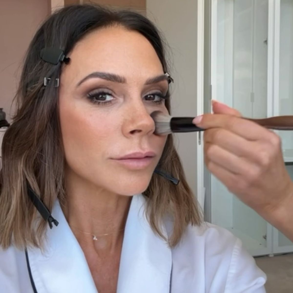 A selfie of Victoria Beckham having her makeup done
