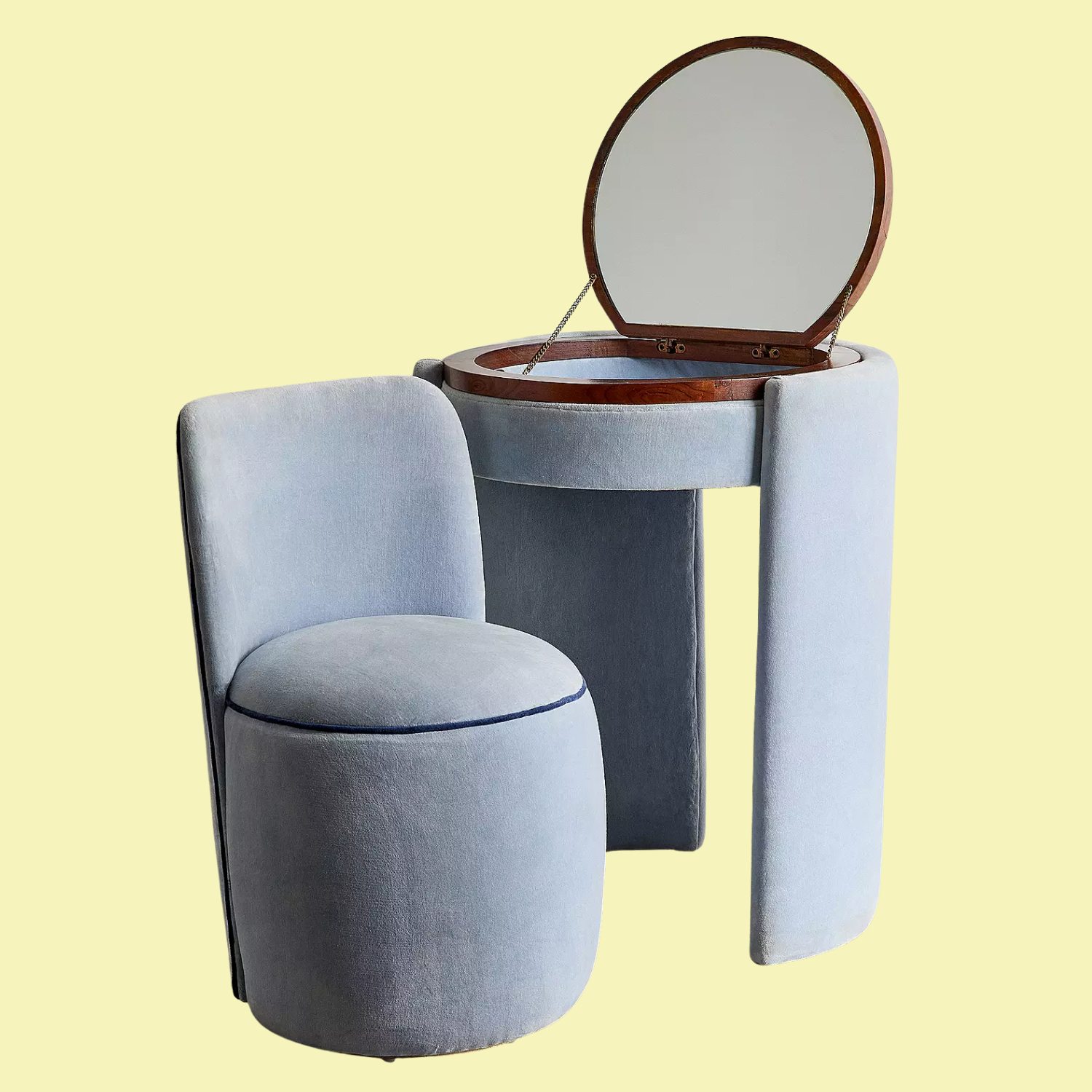 A plush blue vanity and chair against a light yellow background