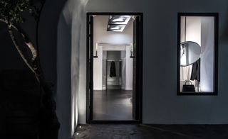Interior of the Alchemist Boutique, looking through a doorway at clothes on display