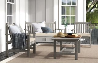 A wooden outdoor seating set in gray-washed timber