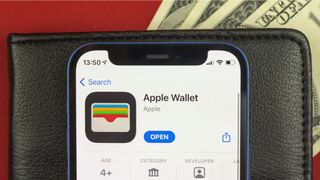 Apple wallet in front of a phone lying on a wallet